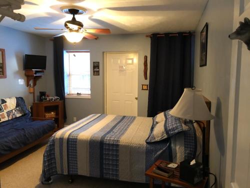 a bedroom with a bed and a ceiling fan at McKinley View B&B in Trapper Creek