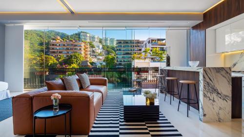 a living room with a couch and a view of a city at PIER 57 - 709 Stunning View 2 BR Romantic Zone in Puerto Vallarta