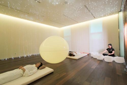 a group of people laying on beds in a room at WE Hotel Jeju in Seogwipo