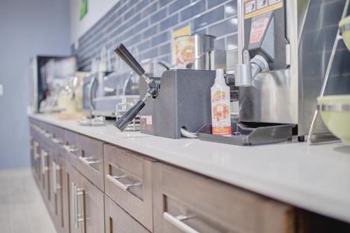a counter in a kitchen with a row of sinks at Quality Inn & Suites in Suffolk