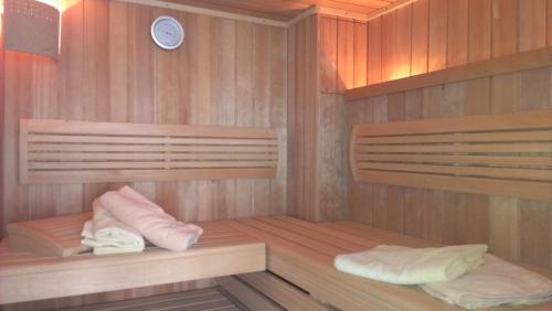 a sauna with two beds and a clock on the wall at Pension Haus Diefenbach in Heimbach