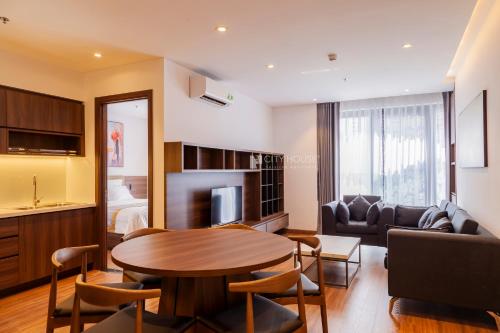 a living room with a table and a couch at CityHouse - Kim Nguyên in Ho Chi Minh City
