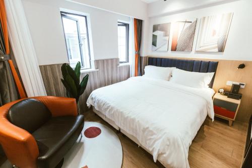 a hotel room with a bed and a chair at Shanghai Fish Inn People Square in Shanghai