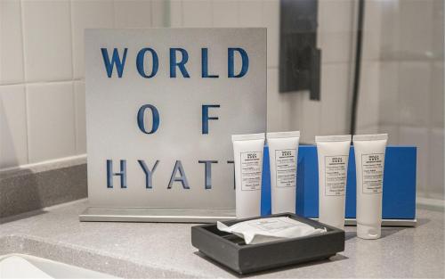 a group of three products on a counter next to a sign at BEI Zhaolong Hotel, a JdV by Hyatt in Beijing