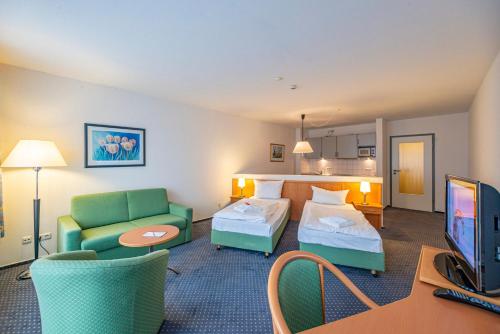 Ένα ή περισσότερα κρεβάτια σε δωμάτιο στο Hotel Rostock West im "Kritzmow Park"