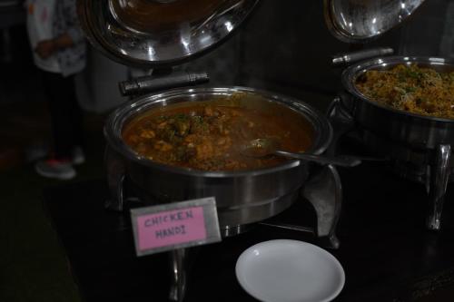 a pot of food sitting on top of a stove at Relax Adventure Resort in Igatpuri