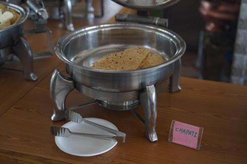 a mixer on a table with a plate and utensils at Relax Adventure Resort in Igatpuri