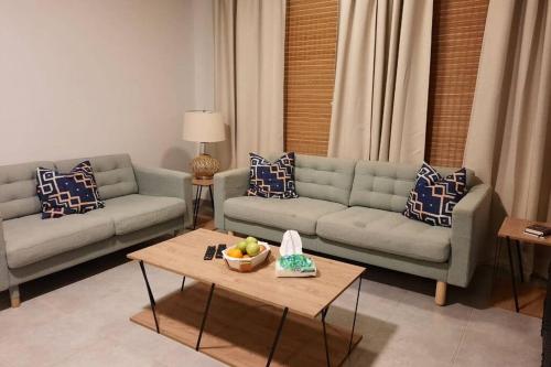 a living room with two couches and a table at سن رايز in King Abdullah Economic City