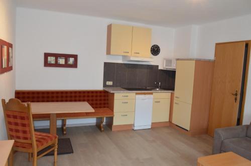 a small kitchen with a table and a table and a kitchen gmaxwell gmaxwell gmaxwell gmaxwell at Haus Regenbogen in Pertisau