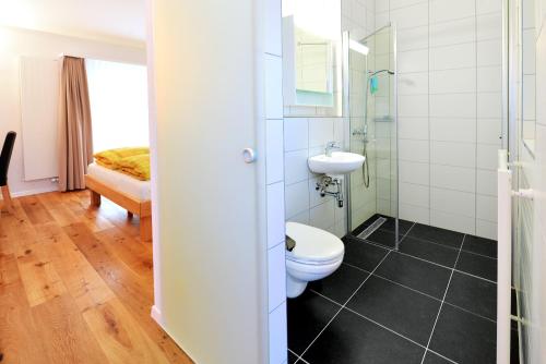 a bathroom with a toilet and a sink at Hotel de la Gare in Sugiez