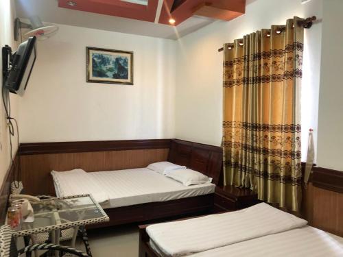 Кровать или кровати в номере Hong Dao Hotel