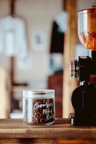 a glass jar of coffee beans next to a blender at Fukuoka Guesthouse SHIP in Fukuoka