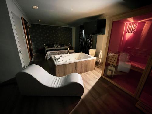 a large bathroom with a tub and a bed at La Siesta in Villamarciel