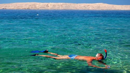 a man laying in the water with a frisbee at Terra Park SpiritoS in Kolan