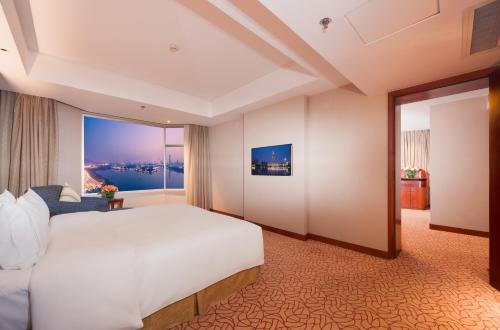 a hotel room with a bed and a large window at Shu Guang International Hotel in Nanjing