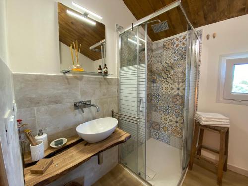 a bathroom with a sink and a shower at Glamping Tenuta San Pierino Agriturismo in Rosignano Marittimo