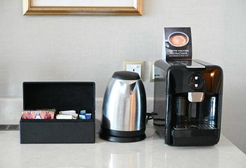 a coffee maker and a coffeemaker next to a box at Shangri-La Jakarta in Jakarta
