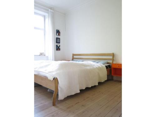 a white bedroom with a bed and a window at ApartmentInCopenhagen Apartment 414 in Copenhagen