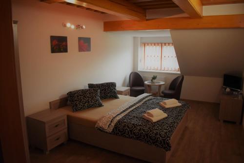 a bedroom with a bed with two pillows at Motel Roubenka in Týniště nad Orlicí
