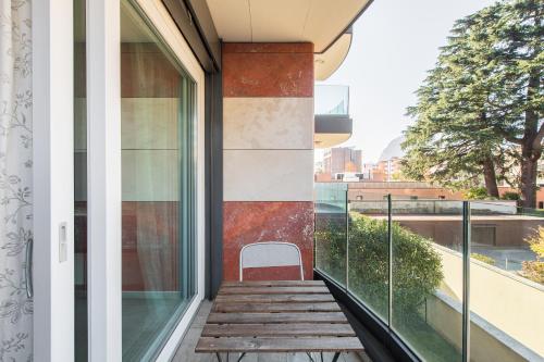 a balcony with a chair on a building at Roggia Apartments by Quokka 360 - central flats with parking space in Lugano