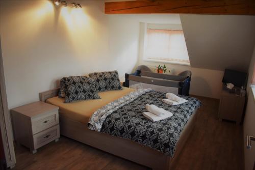 a bedroom with a bed with two towels on it at Motel Roubenka in Týniště nad Orlicí