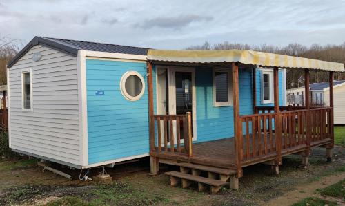 una casita azul y blanca con porche en Assist Mobil home 328 - Mobil Home élégance 3 chambres 6 couchages, en Onzain