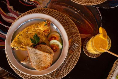 a bowl of food with bread and a sandwich on a table at Amihan Beach Cabanas in Bantayan Island