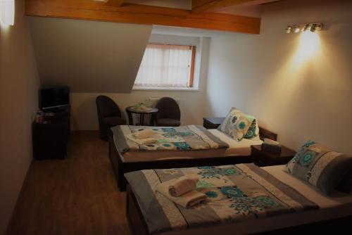 a hotel room with two beds and a window at Motel Roubenka in Týniště nad Orlicí