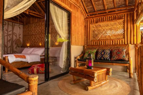 a bedroom with a bed and a table in a room at Amihan Beach Cabanas in Bantayan Island