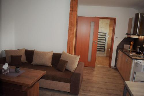 a living room with a couch and a table at Motel Roubenka in Týniště nad Orlicí