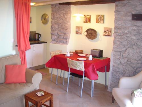 a living room with a red table and chairs at Romantic Studio in Funchal