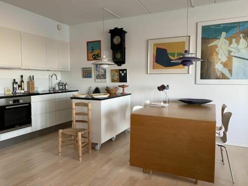 a kitchen with a counter and a table in it at ApartmentInCopenhagen Apartment 1417 in Copenhagen