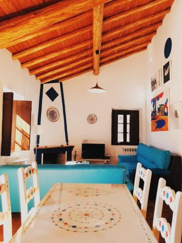 a dining room with a table and chairs at Quinta do Sardanito de Tras in Zambujeira do Mar
