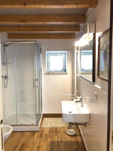 a bathroom with a glass shower and a sink at Palazzo Romanelli B&B in Trani