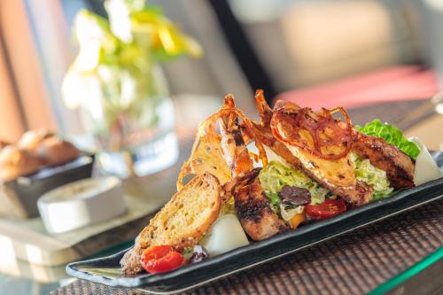 a plate of food sitting on a table at Cap Maison Resort & Spa in Cap Estate