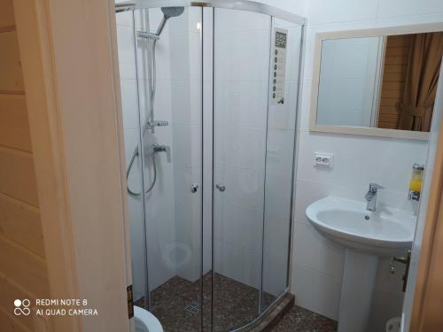 a bathroom with a shower and a sink at Pogar White in Slavske