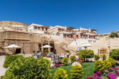 a large garden with a balcony overlooking a city at Petra Guest House Hotel in Wadi Musa