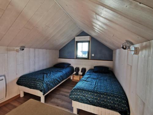 a bedroom with two beds in a attic at Le Petit Renard in Saint-Jouin-Bruneval
