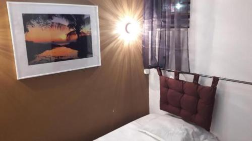 a hotel room with a bed and a lamp at Hotel Du Centre in Saint-Denis