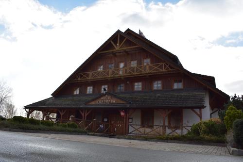 a large wooden building on the side of a road at Motel Roubenka in Týniště nad Orlicí