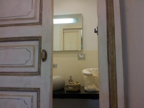 a bathroom door with a mirror and a chair at Residenza Bendinelli-Sauli in Genova
