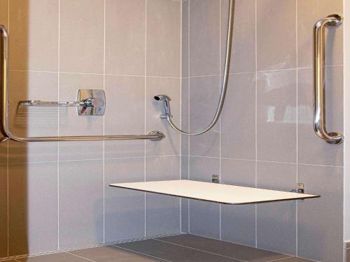 a shower with a shelf in a bathroom at ibis Sao Paulo Tatuape in São Paulo