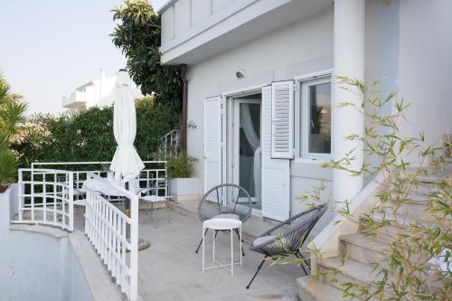 a patio with a table and chairs and an umbrella at Vila Visnjic in Grebaštica