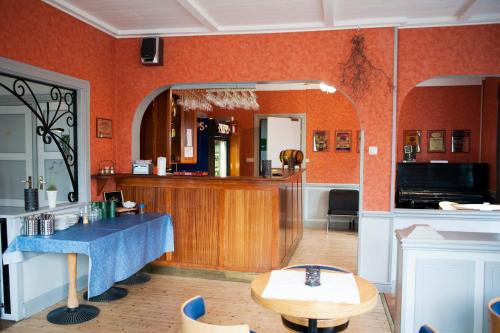 a kitchen with orange walls and a table and a counter at Reftele Wardshus in Reftele