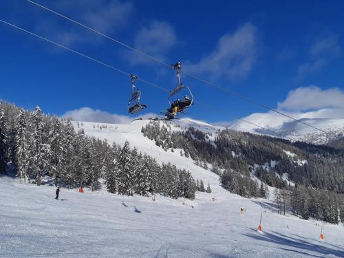 a person is on a ski lift in the snow at Chalet Verdino in Bad Kleinkirchheim