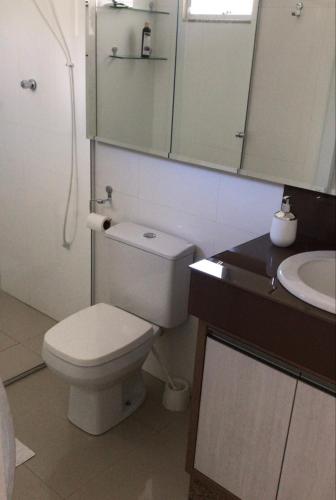 a bathroom with a white toilet and a sink at Bell vale in Louro Müller