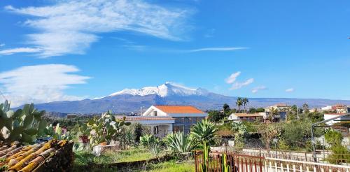 Blick auf einen Berg von einer Stadt mit Häusern in der Unterkunft La casa del sole "tra l'Etna e il mare" in Acireale