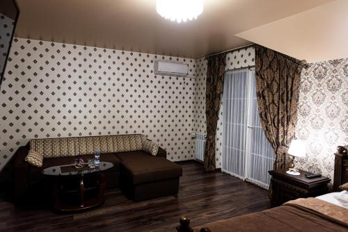 a hotel room with a couch and a table in a room at Едем in Brzezhany