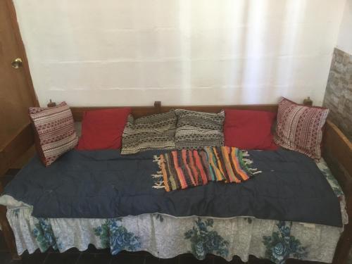 a bed with blankets and pillows on top of it at mi pesadilla2 in Salinas 