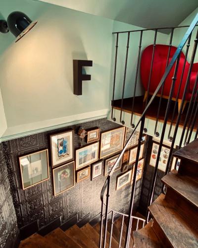 a staircase with a f on a wall with pictures at Fab House - Les Maisons Fabuleuses in Senlis